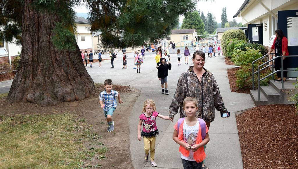 Students run into Fall City Elementary from the playground as the bell sounded the start of the first day of school. (Carol Ladwig/Staff Photo)