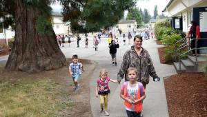 Students run into Fall City Elementary from the playground as the bell sounded the start of the first day of school. (Carol Ladwig/Staff Photo)