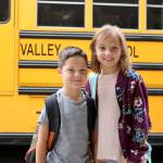 Aiden and Hadley Robbins went to see their friends at the Snoqualmie Elementary bus lane. (Evan Pappas/Staff Photo)