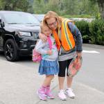Desi Frink hugs crossing guard Joan Graves before excitedly entering the school for her first day of first grade. (Evan Pappas/Staff Photo)