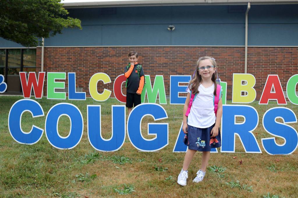 Nolan and Paisley Wais shake off the nerves of stating a new year at school before heading inside. (Evan Pappas/Staff Photo)