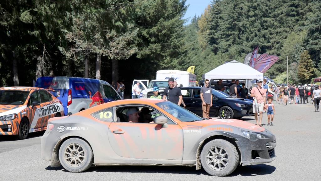 A dirt-covered car makes its way back up to the show after one of the drivers takes a raffle winner for a ride.                                (Evan Pappas/Staff Photo)