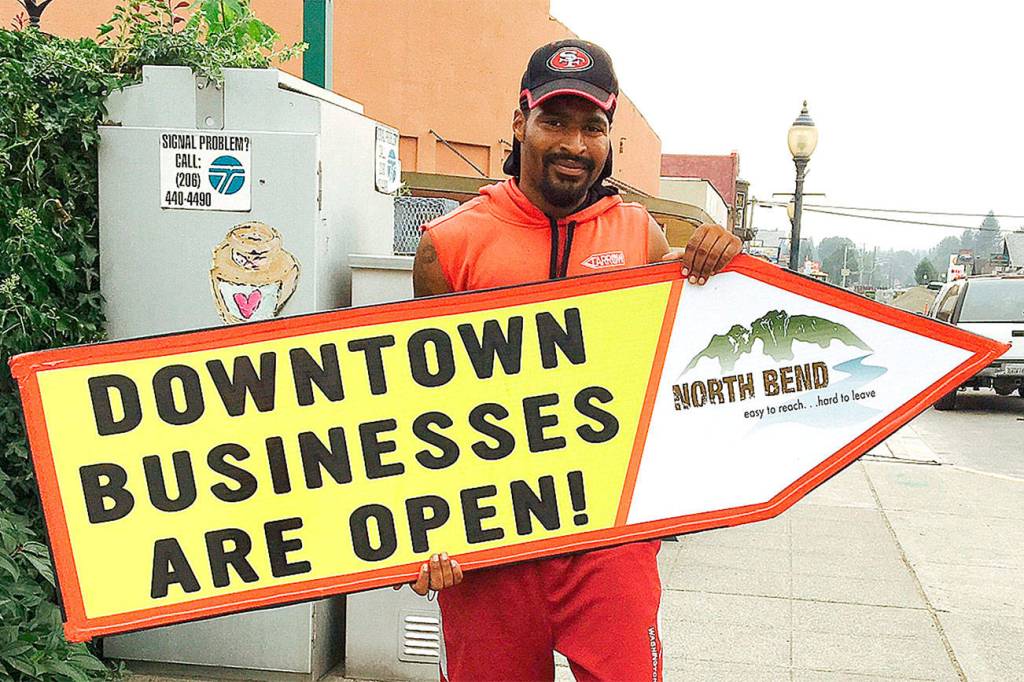 Sign spinner advertises for downtown North Bend businesses, affected by construction work