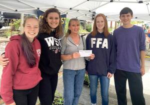 Debbie Monroe, treasurer of Cherry Valley Horticulture Club, presents Cedarcrest High School landscape design team scholarship for national competition. (Courtesy Photo)