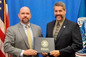 Paul Butki, Acting Superintendent of the Emergency Management Institute congratulates Snoqualmie Fire Chief Mark Correira on his completion of FEMA&rsquo;s Emergency Management Advanced Academy. (Photo courtesy of Shane Gibbon, FEMA)