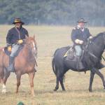 Two cavalrymen ride through the smoke caused by cannon fire. (Evan Pappas/Staff Photo)