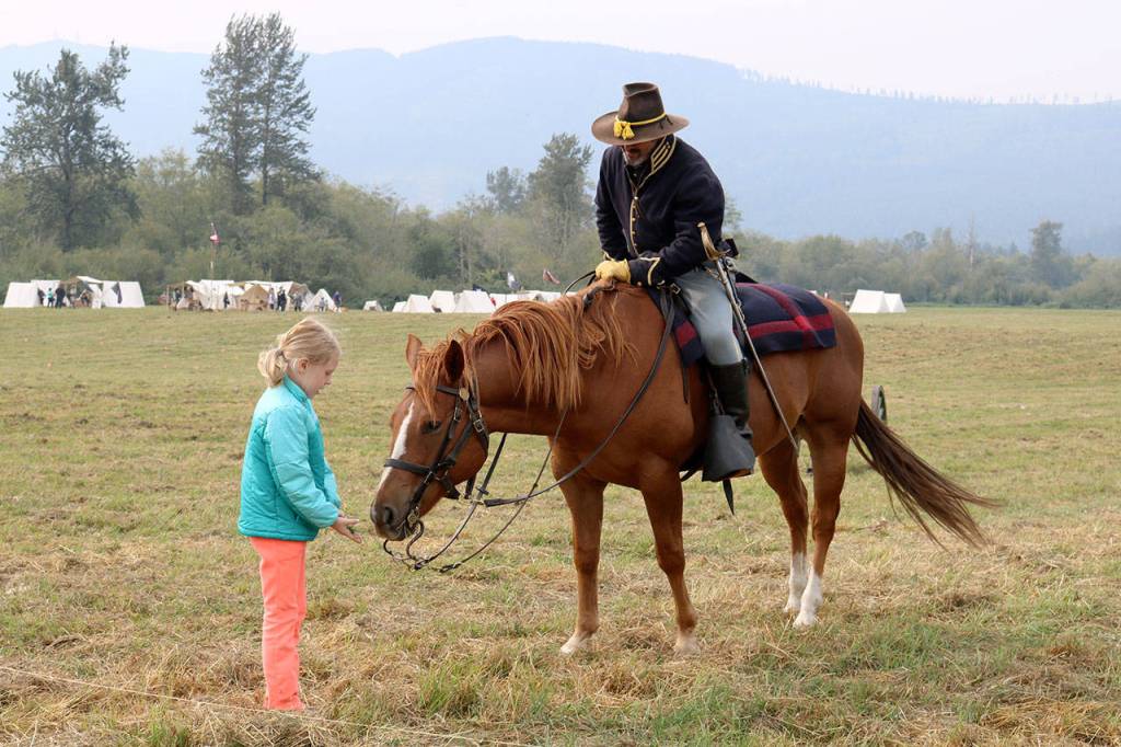 Emily B, 9, meets one of the horses after the battle. (Evan Pappas/Staff Photo)