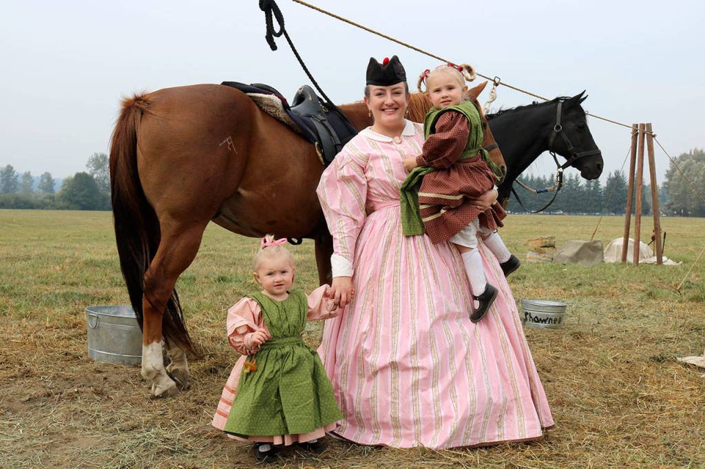 Sarah Silvia takes Trinity and Shelby to pet the horses. (Evan Pappas/Staff Photo)