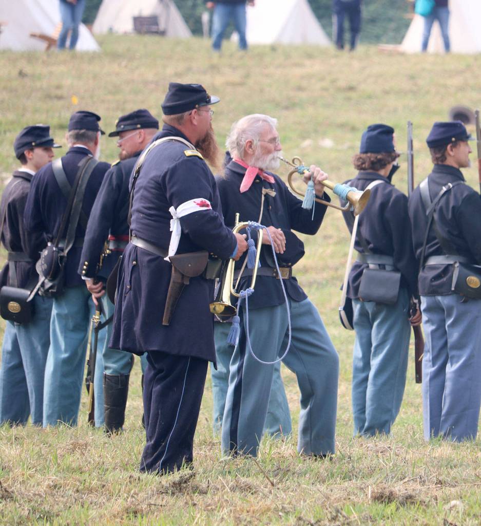 Two buglers stand behind the union soldiers to help guide the action with their short signals. (Evan Pappas/Staff Photo)