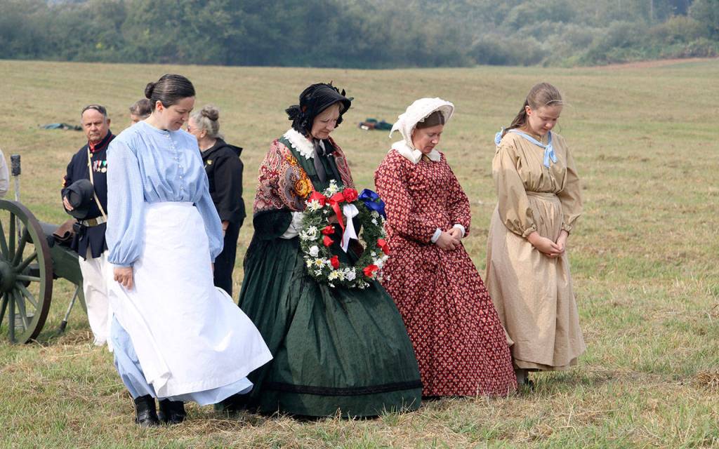 The battle stops as four women bring a wreath onto the field for a brief memorial for all the soldiers who died in the Civil War. (Evan Pappas/Staff Photo)