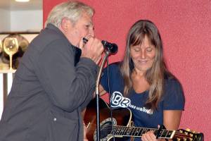 Heather B Blues gets harmonica backup from an audience member.