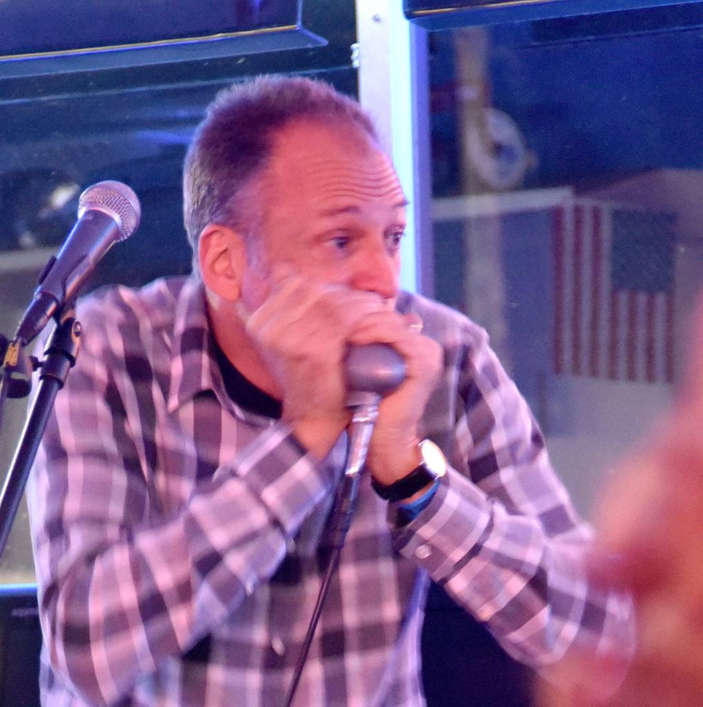 Brian Lee solos on the harmonica. (Carol Ladwig/Staff Photo)