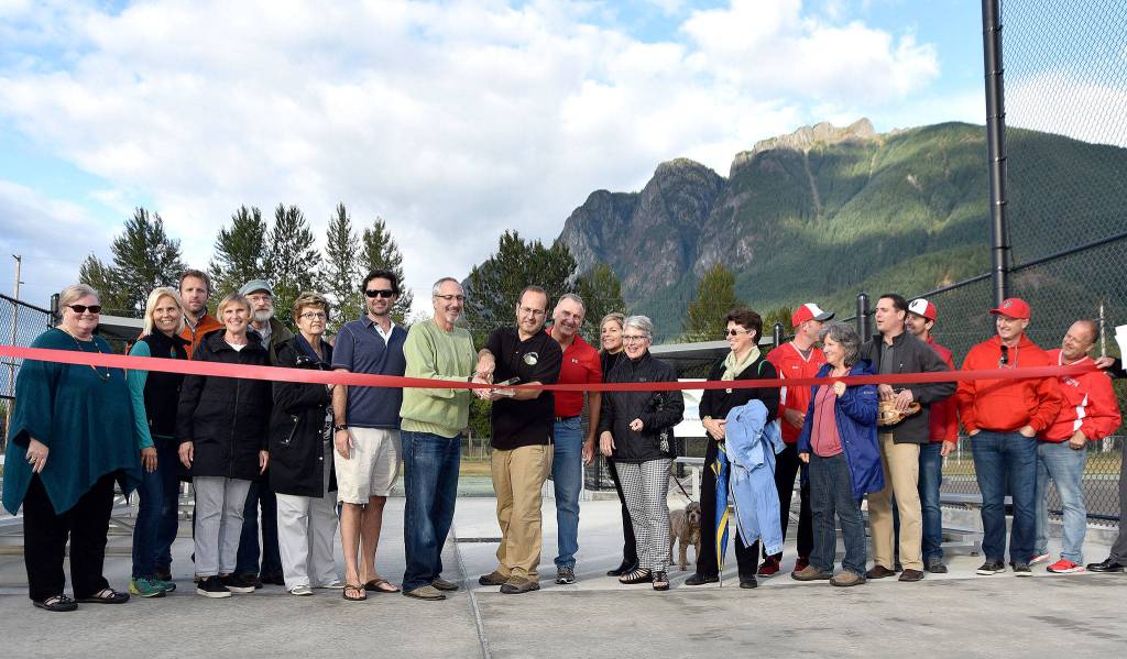 Everyone who had something to do with the latest round of improvements to Torguson Park &mdash; ball field updates, a new restroom and concessions building and a walking trail &mdash; joined in the cutting of the ribbon to celebrate Thursday, Sept. 14 at the park. (Carol Ladwig/Staff Photo)