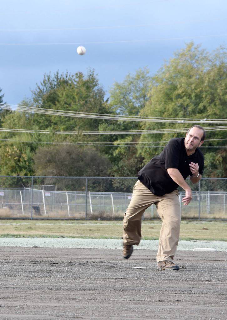 North Bend City Councilman Jonathan Rosen, an advocate of the Torguson Park improvements since they were first proposed, had the honor of throwing out the first pitch Thursday. (Carol Ladwig/Staff Photo)