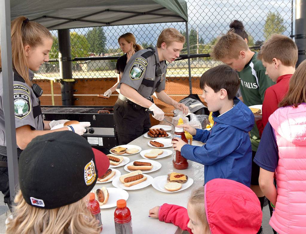 Snoqualmie Police Explorers helped stock a cookout in celebration of the Torguson Park improvements. (Carol Ladwig/Staff Photo)