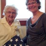 Pearl Moore accepts the U.S. flag that was flown over the Capitol in honor of her 100th birthday, Sept. 18, from King County Councilwoman Kathy Lambert. (Courtesy Photo)