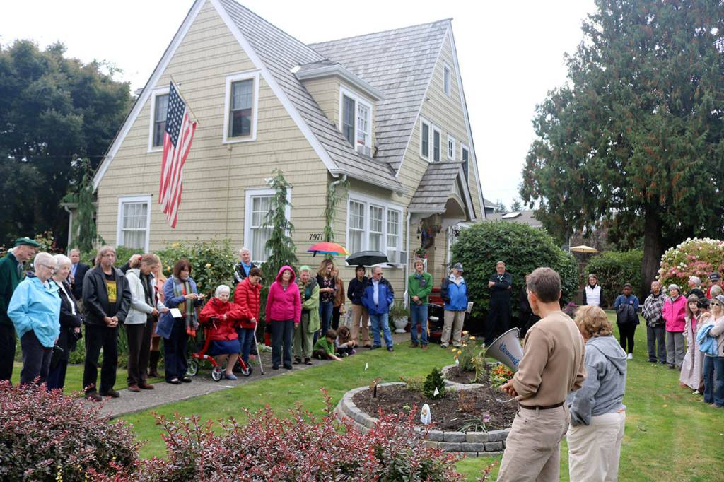 A group of over 60 gather at the Peterson house on the dedication tour to learn about the history of the location. (Evan Pappas/Staff Photo)
