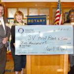 Presenting a $5,000 donation to Snoqualmie Valley Food Bank&rsquo;s Sharon Augenstein, center, are Rotarian Steve Weaver, left, and Rotary President Leesa McKay. (Courtesy Photo)