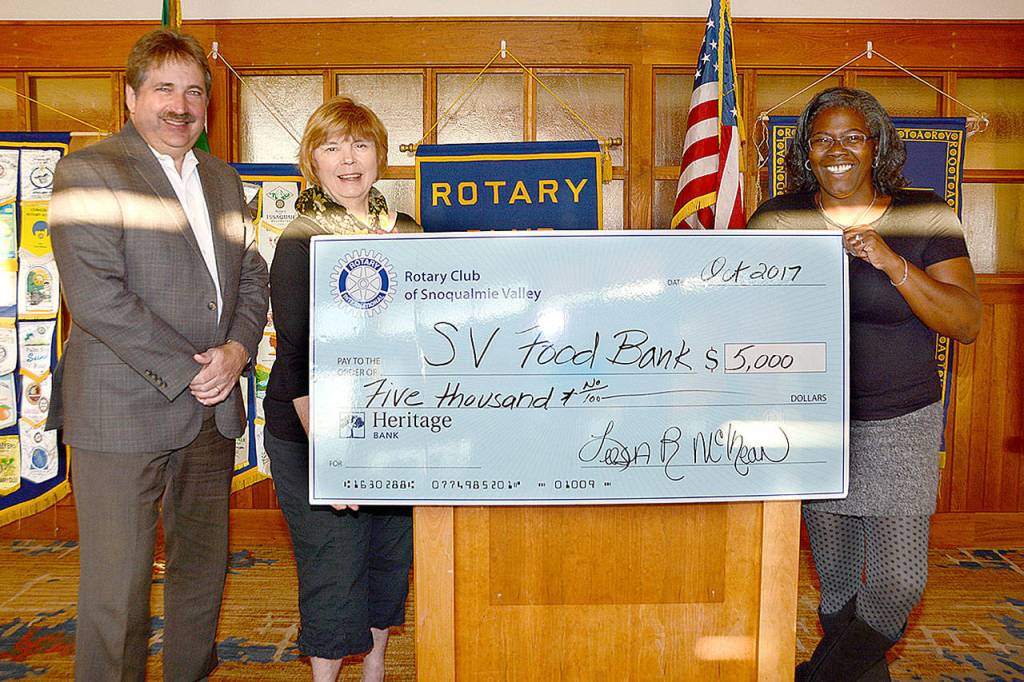 Presenting a $5,000 donation to Snoqualmie Valley Food Bank&rsquo;s Sharon Augenstein, center, are Rotarian Steve Weaver, left, and Rotary President Leesa McKay. (Courtesy Photo)