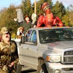 Parker Graves roars as the dinosaur in this float, themed &ldquo;A Night at the Museum.&rdquo; (Carol Ladwig/Staff Photo)