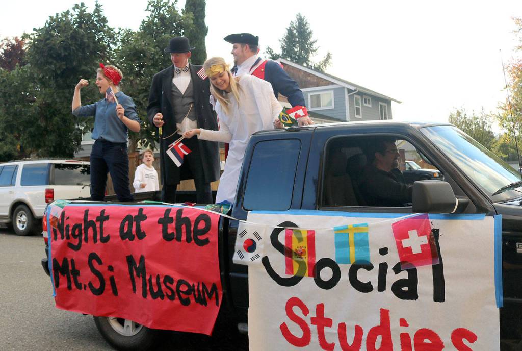 Mount Si social studies teachers pose as famous figures in history on their float. (Carol Ladwig/Staff Photo)