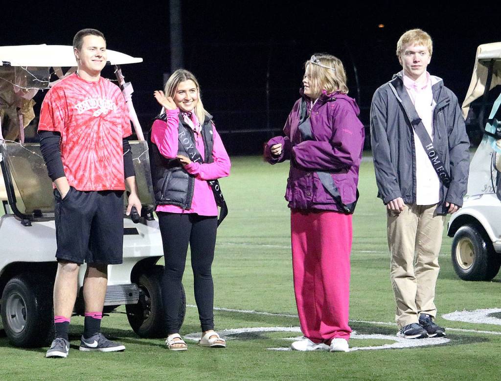 Lexie Rose, second from left, waves as her name is announced as Homecoming Queen. Pictured with her are, from left, Jake Ehrlich, prince of pride, and Olivia Corbin and Dane Bruckner, the duchess and duke of the homecoming court. (Carol Ladwig/Staff Photo)