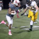 Jesiah Irish works to outrun an Inglemoor defender. (Carol Ladwig/Staff Photo)