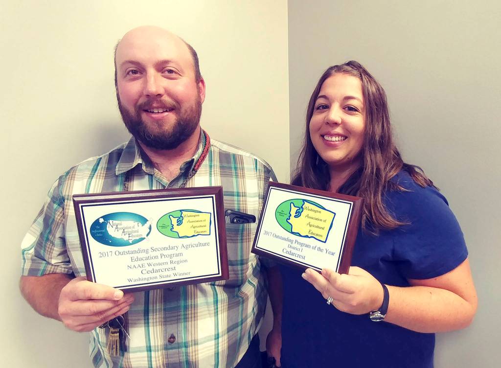 Cedarcrest High School ag program teachers Seth Thomas, left, and Sarah Thomas hold their Ag Program of the Year awards. (Courtesy Photo)