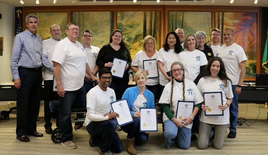 The 2017 Citizens Academy graduates were recognized at the Oct. 23 Snoqualmie City Council meeting. Pictured from left, are: standing - Mayor Matt Larson, James Mayhew, Tom Wood, James Rowland, Jennifer DeShong, Ann Logelin, Julie Gran, Richard Scheel Peggy Shepard, Karl Reinsch Luke Marusiak; and kneeling: Birol Shaha, Kate Schenkman, Iya Brown and Stephanie Rosolack. Graduates not in attendance were Jeff Hamlin, Lesley Shepard, Taylor Schulte, Kim Loop and Sallie Ewen. (Evan Pappas/Staff Photo)