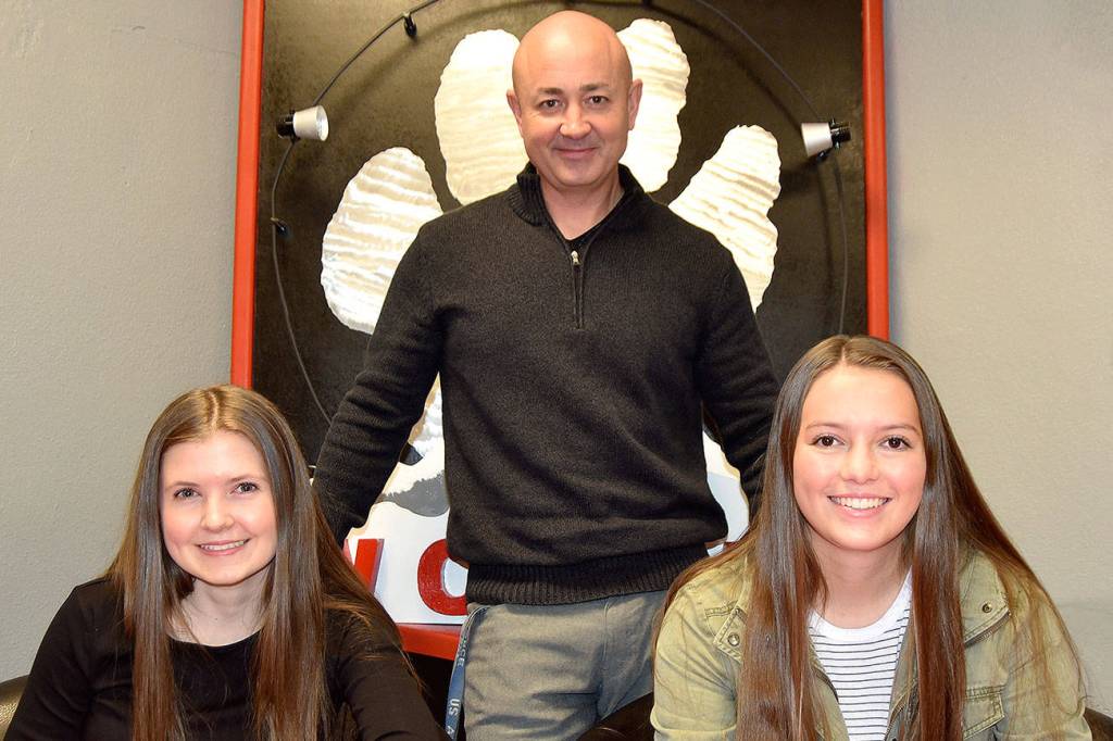 Mount Si students and Associated Student Body officers Adele Werner, left and Grace Lis, right, were assigned to plan the school&rsquo;s annual Veterans Day assembly by ASB advisor Darren Brown, center. The assembly starts at 1:20 p.m., Thursday, Nov. 9 in the high school gym, and is open to the public. (Carol Ladwig/Staff Photo)