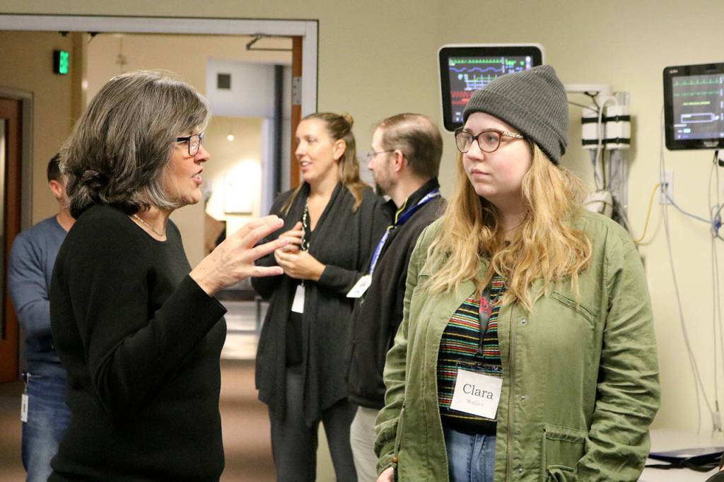 Spacelabs Healthcare software developer manager Shawni Daw speaks to Two Rivers student Clara Wallace about her work. (Evan Pappas/Staff Photo)
