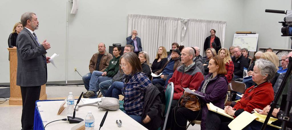 North Bend Mayor Ken Hearing addresses the large and growing crowd at the start of the citys town hall meeting on the Washington State Patrols proposed relocation of a weigh station to a nearby site. (Carol Ladwig/Staff Photo)