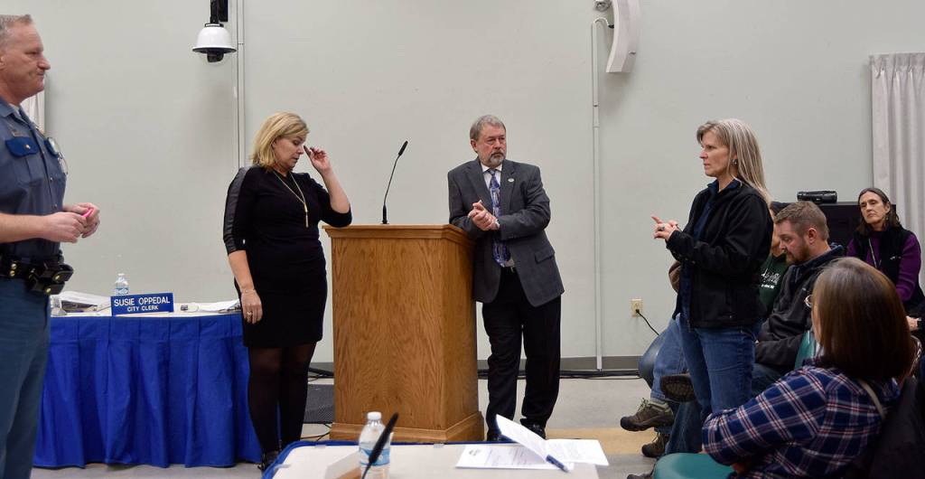 A resident questions Washington State Patrol Captain Michael Dahl on the need for a weigh station right outside North Bend at a town hall meeting on the issue Nov. 7, while City Administrator Londi Lindell and Mayor Ken Hearing listen. (Carol Ladwig/Staff Photo)