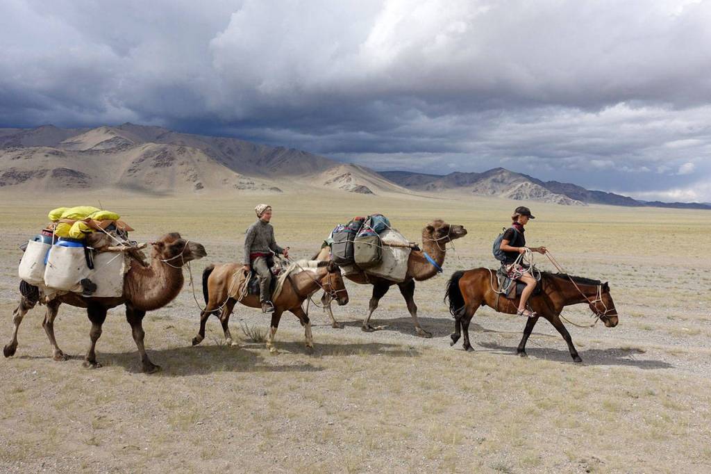 Zuniga and Valkinier make their way across a desert with their camels. (Courtesy Photo)