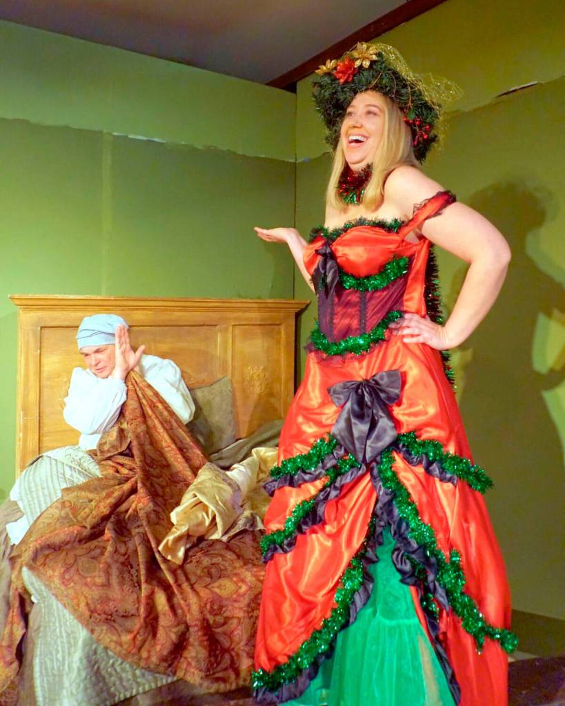 Courtesy Photo                                Scrooge is visited by the Ghost of Christmas Present, played by Natalie Collins.