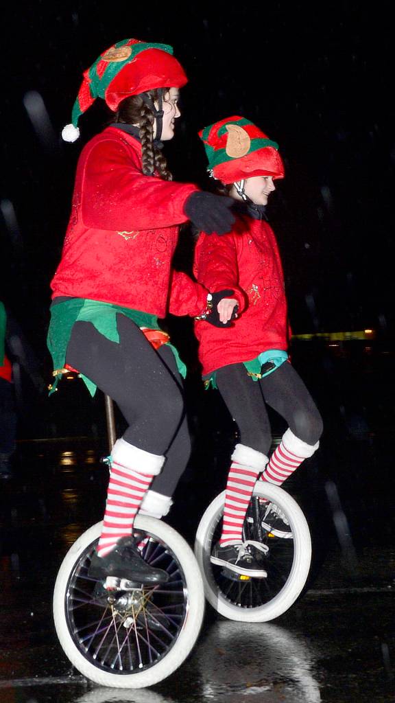 Members of the Snoqualmie Valley Unicycle Club dress up as elves for a performance at the 2016 North Bend tree lighting. (File Photo)