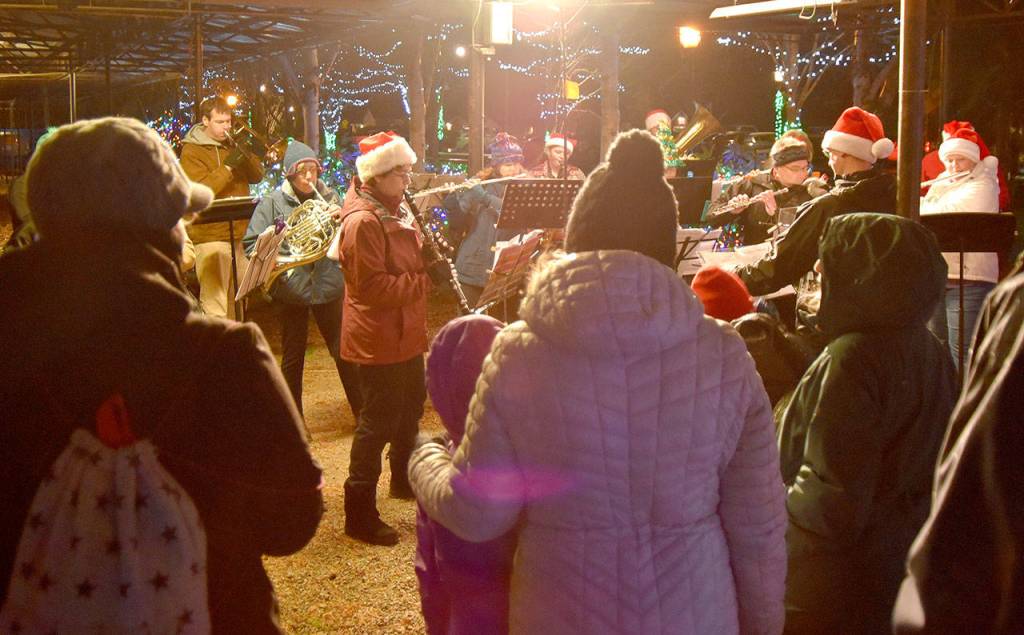 A growing crowd gathered around the Sno-Valley Winds performance Saturday evening at Snoqualmies holiday festival. (Carol Ladwig/Staff Photo)