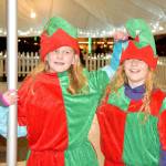 Elves Eleanor Ward and Aeydan Liettla test out Snoqualmies skating rink Saturday, while they wait for their boss, Santa, to arrive. (Carol Ladwig/Staff Photo)