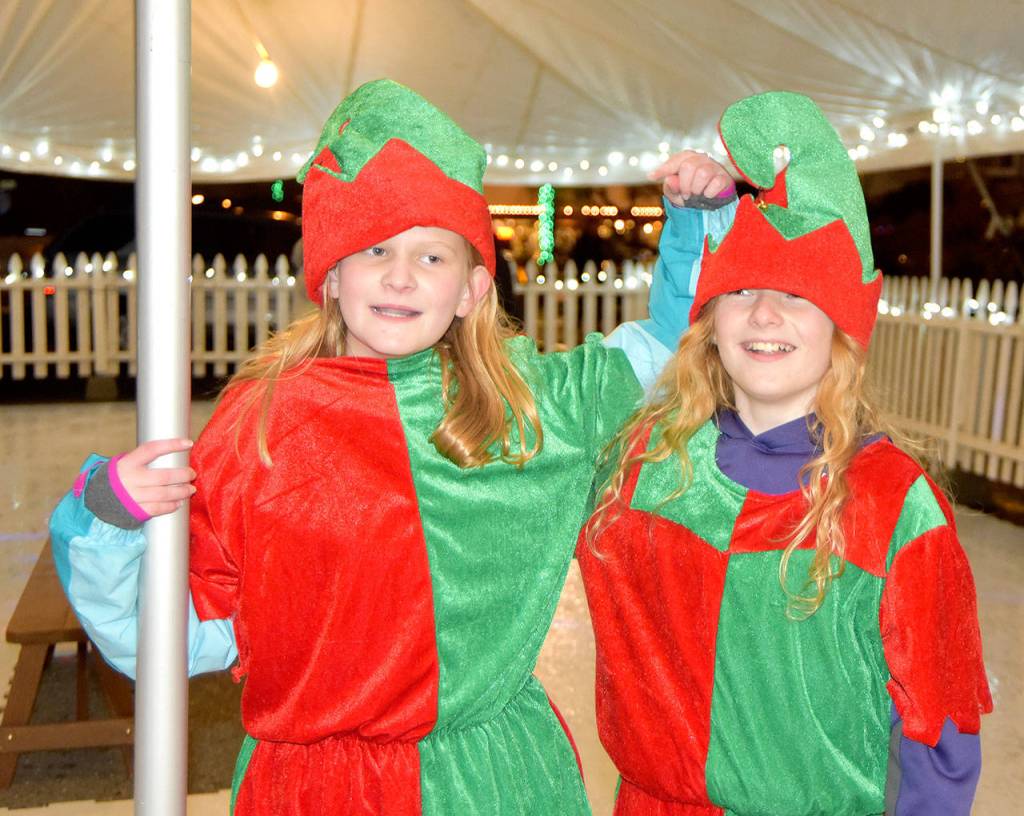 Elves Eleanor Ward and Aeydan Liettla test out Snoqualmies skating rink Saturday, while they wait for their boss, Santa, to arrive. (Carol Ladwig/Staff Photo)