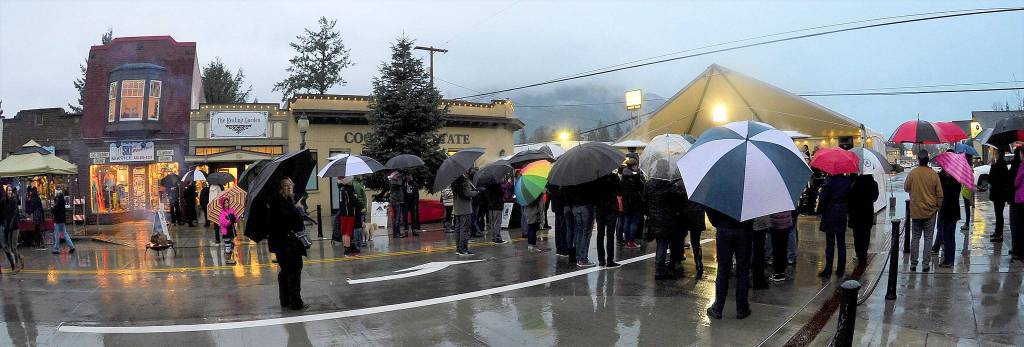 A crowd of umbrellas, and residents, gathered on North Bend Way Saturday for the citys Holly Days celebration. (Photo courtesy of Mary Miller)