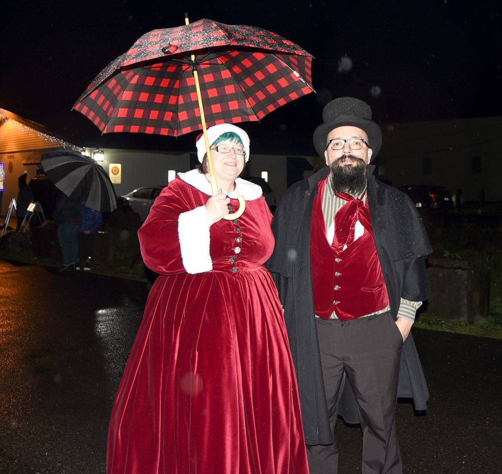 Janice and Eric Oster, owners of Evil Roys Elixirs around the corner from the Christmas in Carnation celebration, donned Victorian holiday garb for the occasion. (Carol Ladwig/Staff Photo)