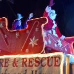 Santa and friends wave at Carnation residents from the Eastside Fire & Rescue Reindeer Engine, pulling into the Christmas in Carnation celebration Saturday evening. (Carol Ladwig/Staff Photo