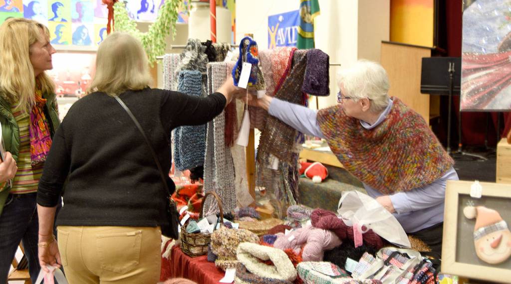 Fiber artist Hilde Gettinger helps shoppers find the right item. (Carol Ladwig/Staff Photo)