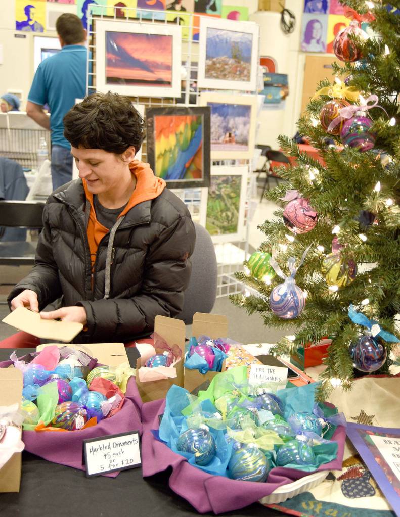 Artist and art teacher Julie Lagace displayed some of her hand-marbled glass ornaments at the holiday fair. (Carol Ladwig/Staff Photo)