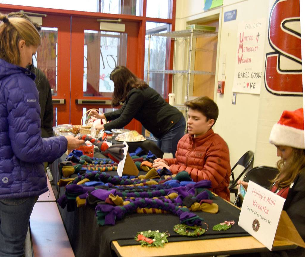 Baked goods, dog toys, and mini wreaths greeted shoppers just inside Chief Kanim Middle School Saturday at the Fall City Holiday Market. (Carol Ladwig/Staff Photo)