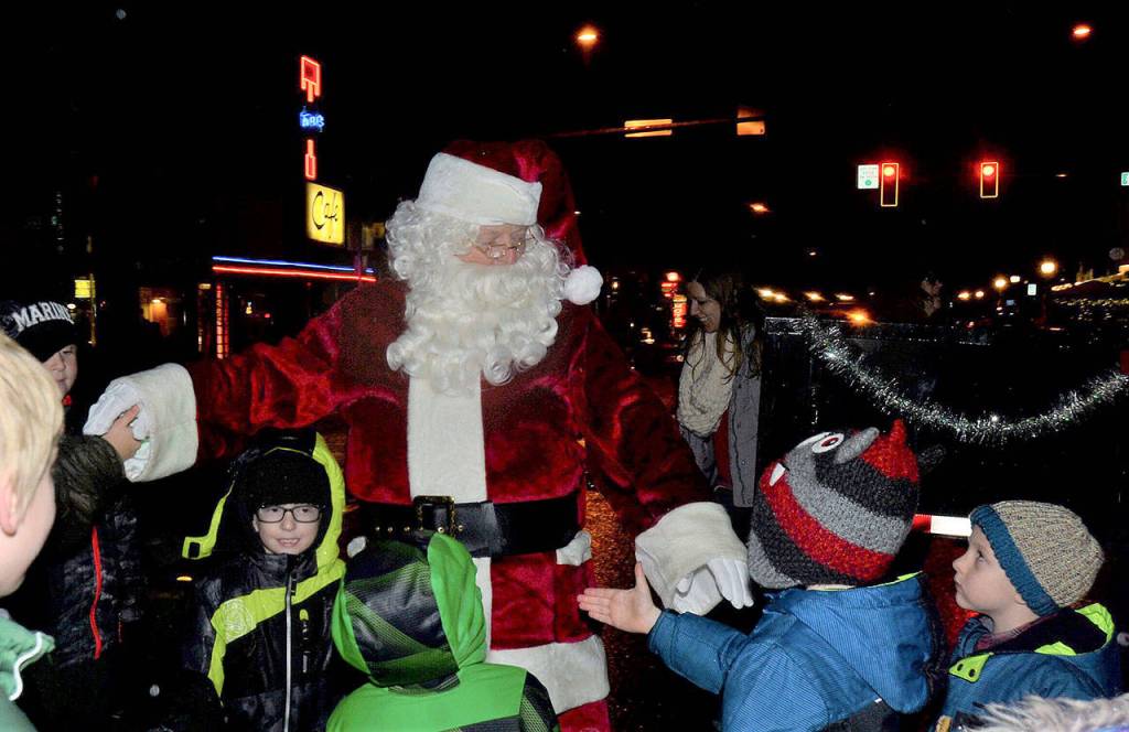 Santa greets excited children in downtown North Bend. (Photo courtesy of Mary Miller)