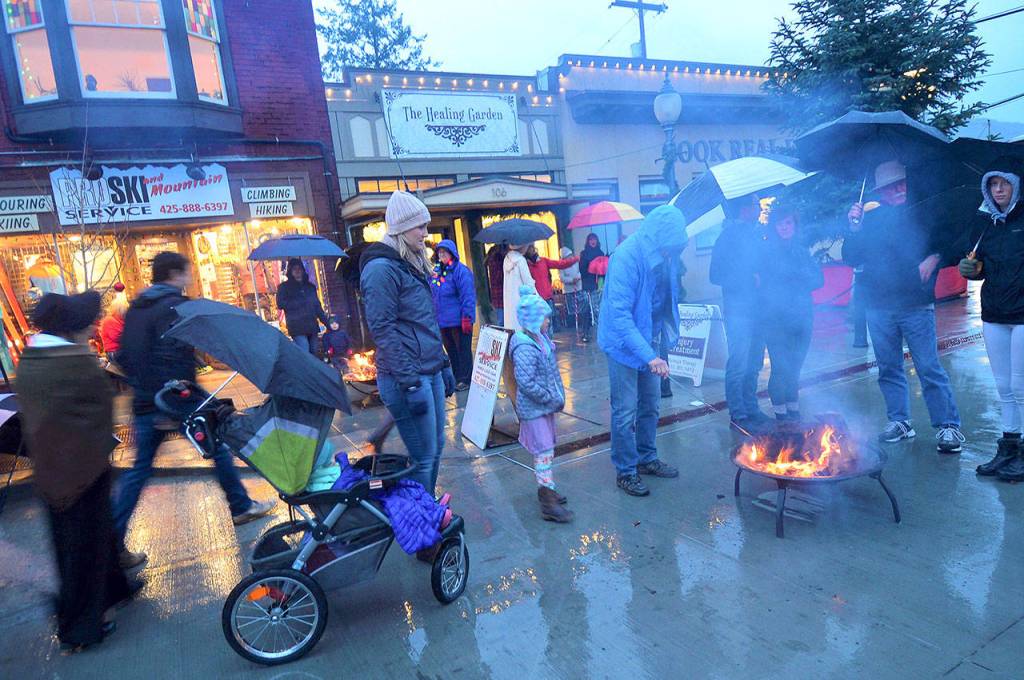 A group of residents gathers around the firepit Saturday during North Bends Holly Days celebration. (Photo courtesy of Mary Miller)