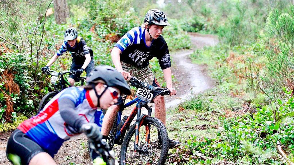 Tyler Bommarito, center, followed by Cole Landreneau, races to cut off an opponent on the trail. (Courtesy Photo)