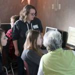 Morgan Chapman, Alexis Meyers, and Connie Zimmerman ask Lake for help with one of the Past Perfect features. (Evan Pappas/Staff Photo)