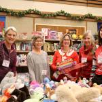 Giving Tree volunteers work to organize the event Thursday morning as the first shoppers enter the church. From left: Debby Peterman, Sandy Emerson, Diane Garding, Ruth Maule, and Christine Copitzsky. (Evan Pappas/Staff Photo)